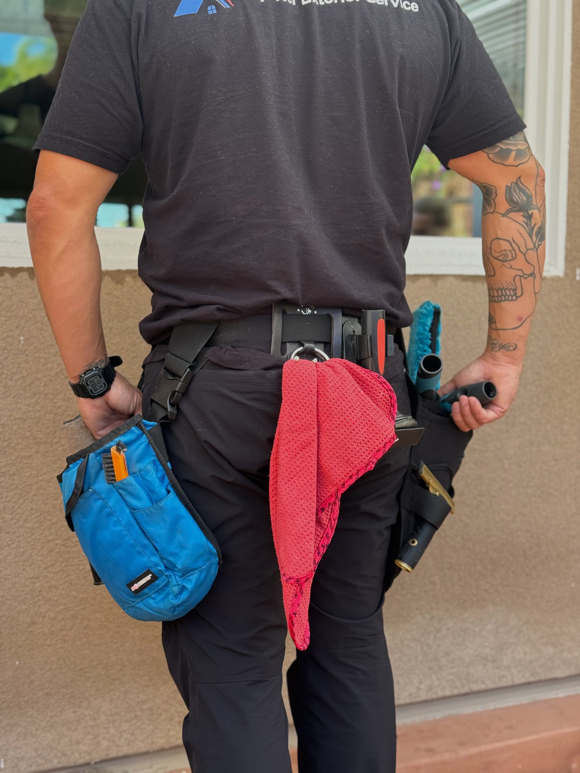 Top Tier Exterior Service technician with professional cleaning equipment and tool belt